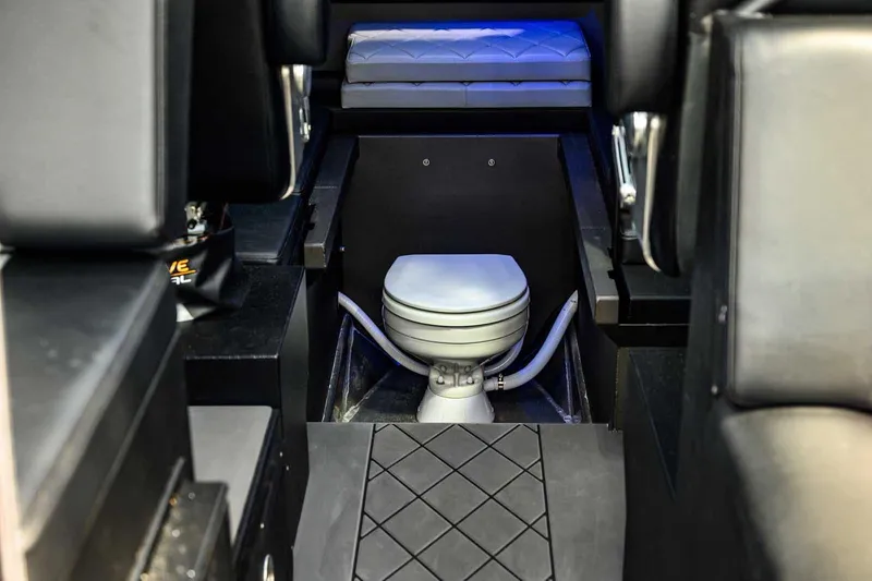 Slide: The Image of Interior of 2024 StabiX 240UCC boat featuring a compact marine toilet. - 21