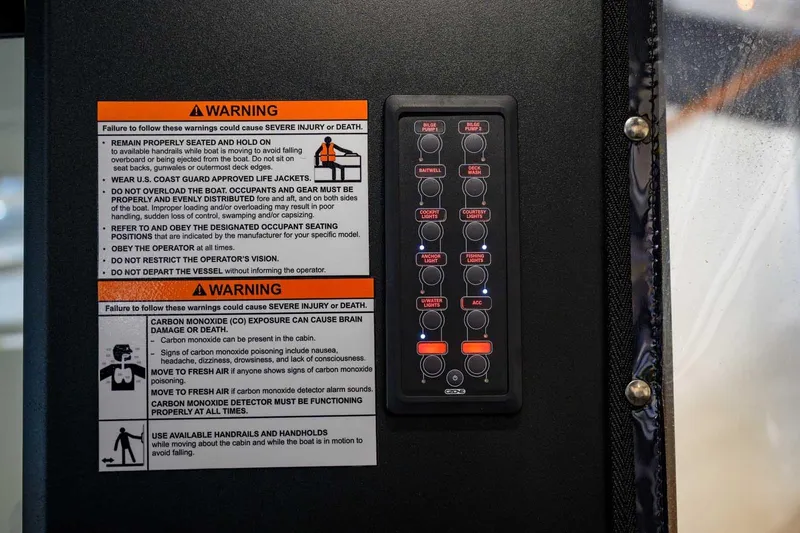 Slide: The Image of Control panel and safety warnings on StabiX 240UCC boat, 2024 model. - 24