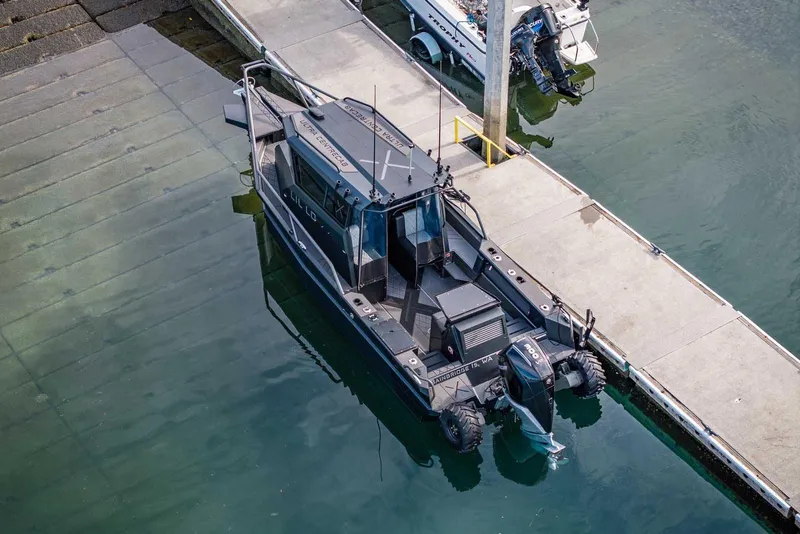 Slide: The Image of Aerial view of 2024 StabiX 240UCC boat docked at a marina. - 5