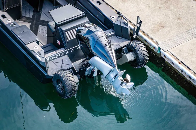 Slide: The Image of Amphibious vehicle StabiX 240UCC 2024 with outboard motor docked at a pier. - 6