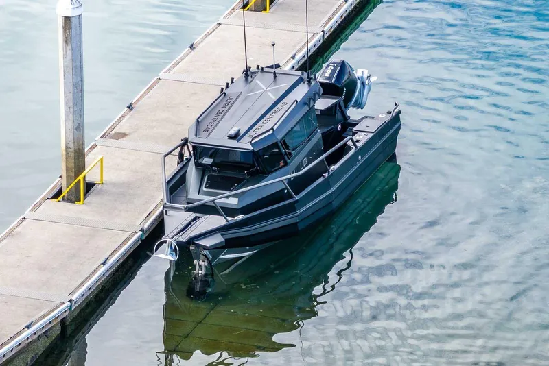 Slide: The Image of A sleek 2024 StabiX 240UCC boat docked at a marina. - 7