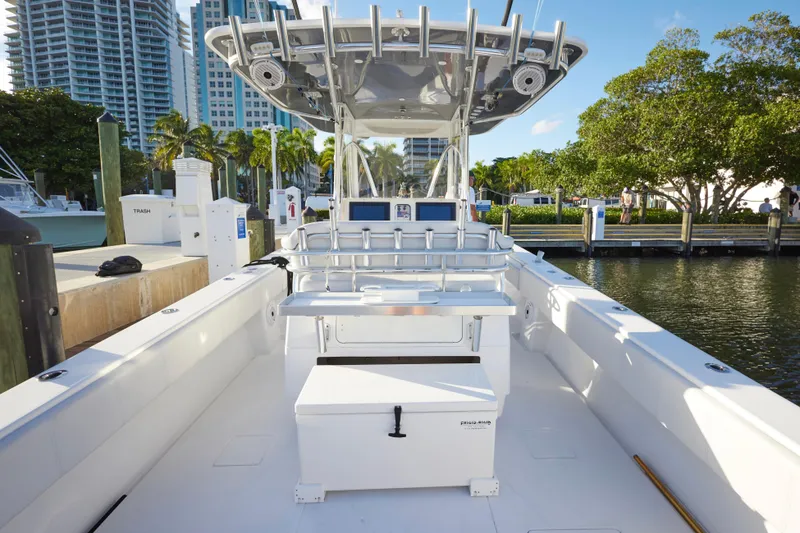 Slide: The Image of 2014 Contender 39 ST boat docked, featuring spacious deck and modern amenities. - 14
