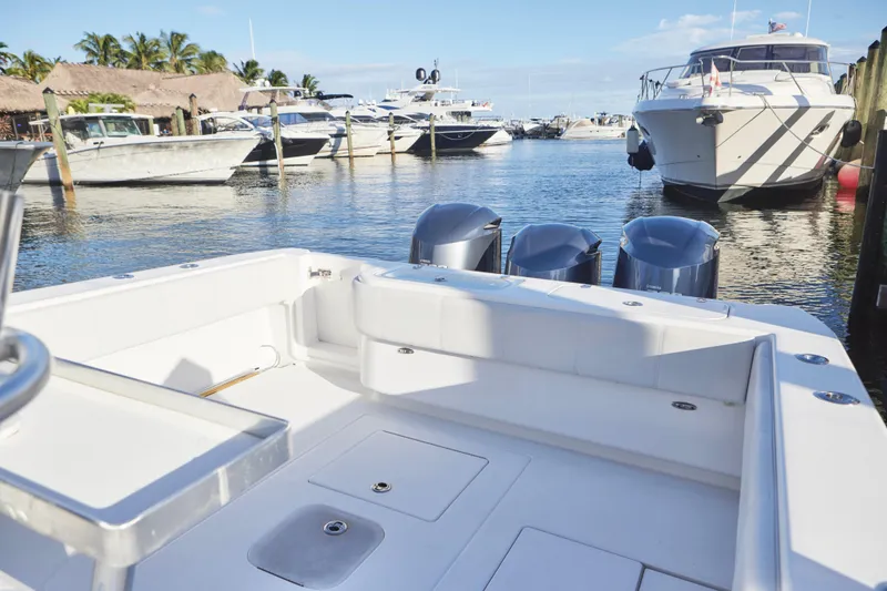 Slide: The Image of 2014 Contender 39 ST boat docked in a marina with other vessels. - 15