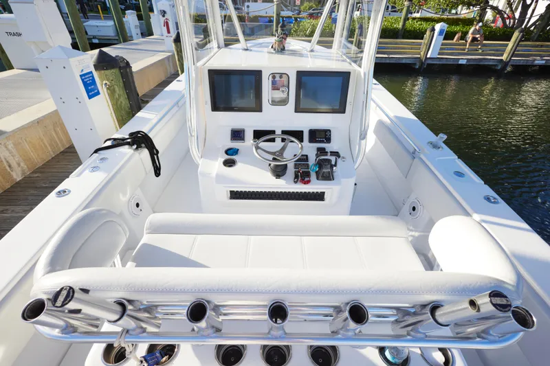 Slide: The Image of 2014 Contender 39 ST boat interior with helm, dual screens, and rod holders. - 16