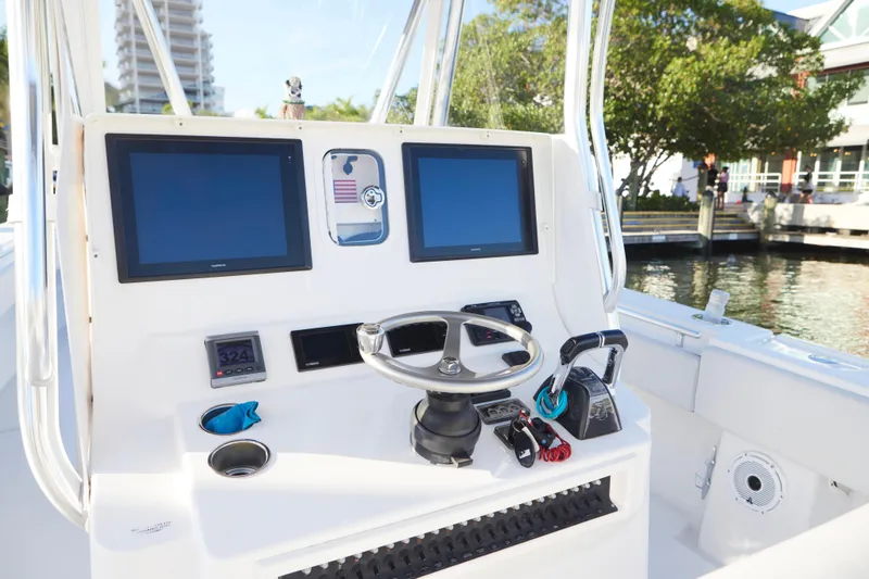 Slide: The Image of 2014 Contender 39 ST boat helm with dual screens and steering wheel. - 17