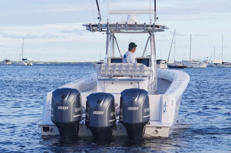 Slide: The Image of 2014 Contender 39 ST boat with triple Yamaha engines on the water. - 4