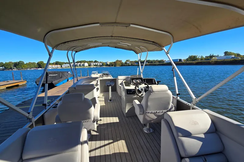 Slide: The Image of 2023 G3 Select 22RC pontoon boat docked on a sunny lake. - 12