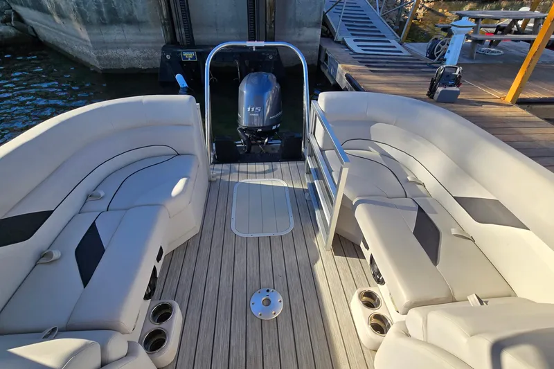 Slide: The Image of 2023 G3 Select 22RC pontoon boat interior with plush seating and outboard motor. - 16