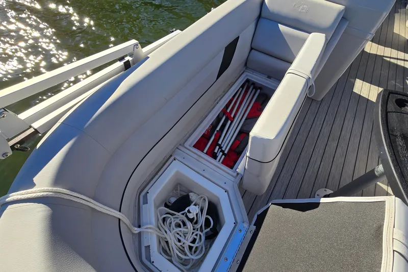 Slide: The Image of 2023 G3 Select 22RC boat interior with open storage compartment and safety equipment. - 22