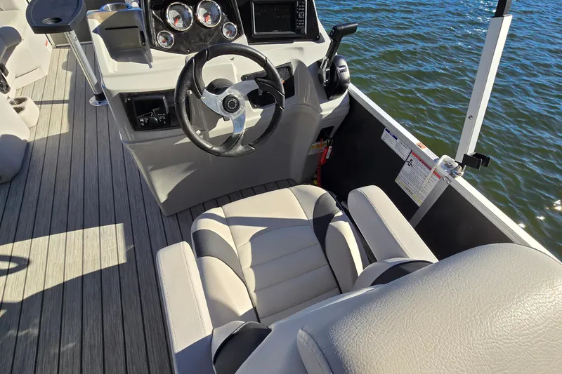 Slide: The Image of 2023 G3 Select 22RC boat interior with steering wheel and seating, on water. - 25