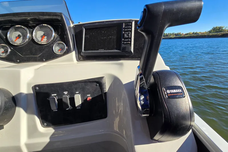 Slide: The Image of 2023 G3 Select 22RC boat dashboard with Yamaha controls and Garmin display on water. - 27