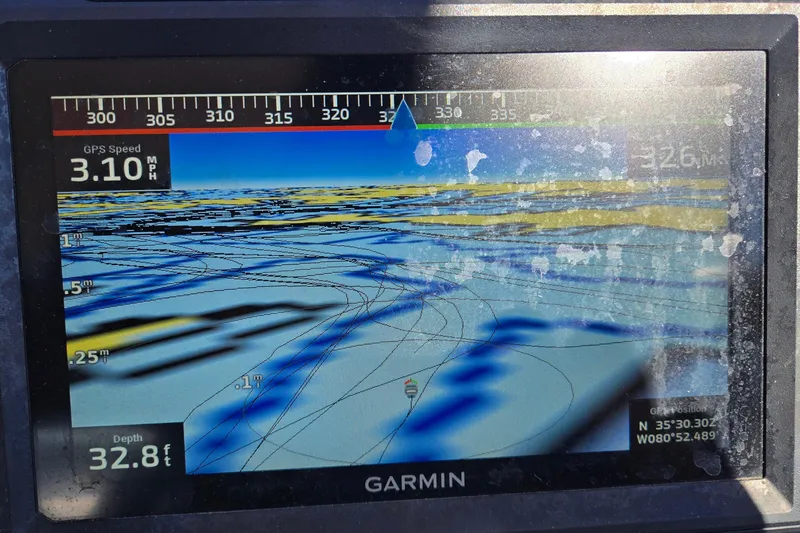 Slide: The Image of Garmin GPS display showing speed, depth, and coordinates on a G3 Select 22RC boat. - 40