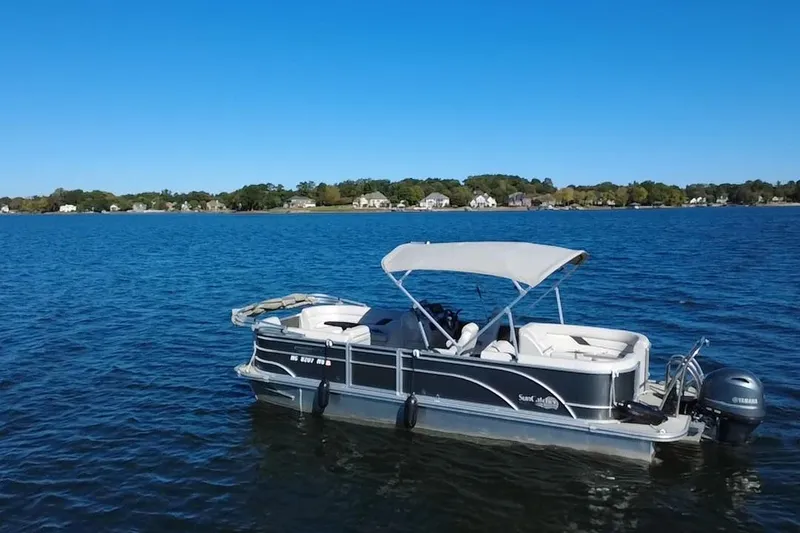 Slide: The Image of 2023 G3 Select 22RC pontoon boat on a serene lake under clear blue skies. - 58