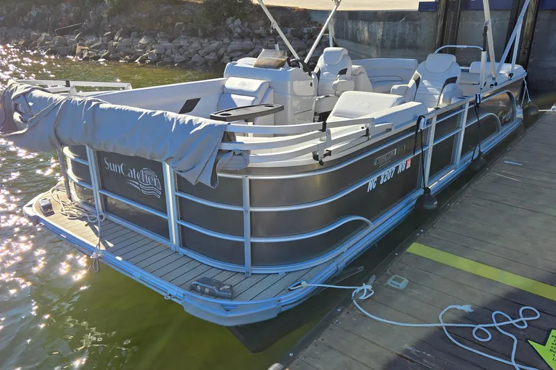 Slide: The Image of 2023 G3 Select 22RC pontoon boat docked, featuring SunCatcher branding. - 8