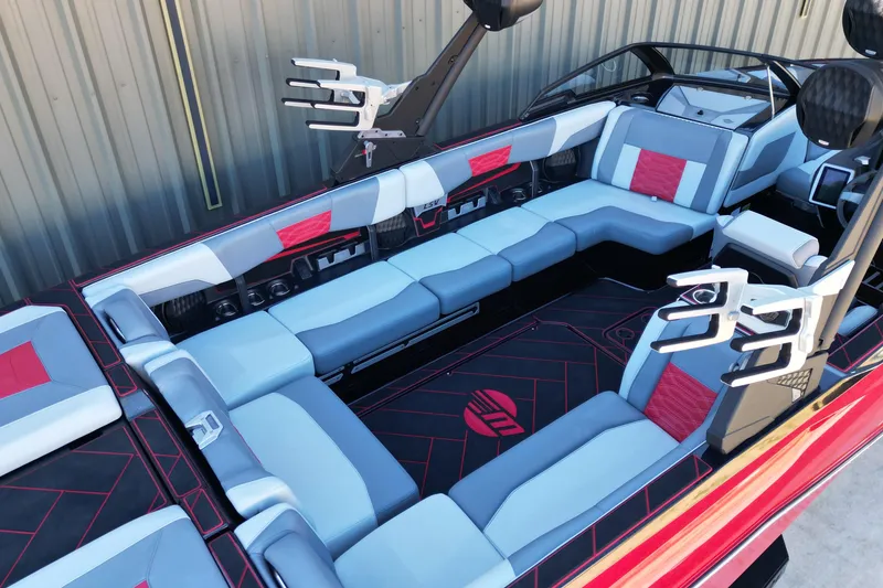 Slide: The Image of 2023 Malibu Wakesetter 25 LSV interior with red and gray seating, sleek design. - 11