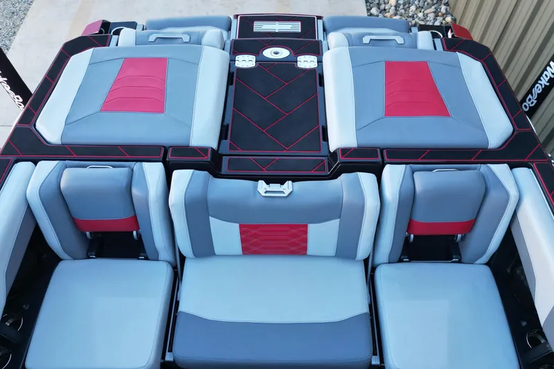 Slide: The Image of 2023 Malibu Wakesetter 25 LSV interior with red and gray seating design. - 12