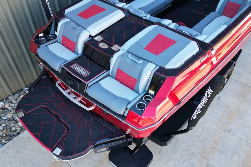 Slide: The Image of 2023 Malibu Wakesetter 25 LSV boat with stylish red and gray seating. - 13