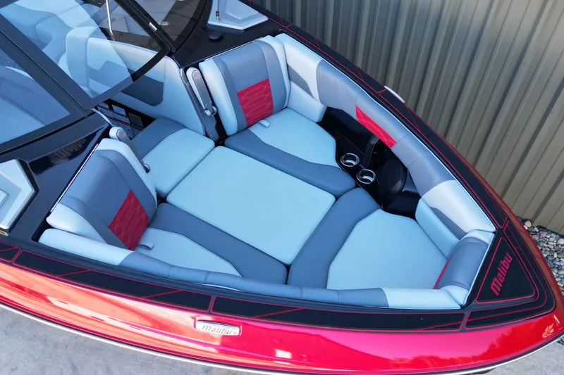 Slide: The Image of 2023 Malibu Wakesetter 25 LSV boat interior with red and gray seating. - 7