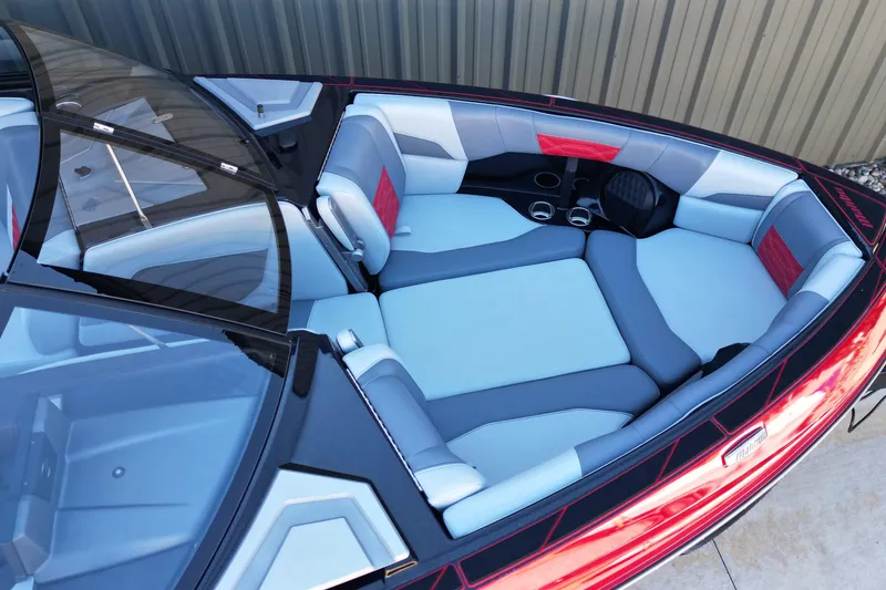 Slide: The Image of 2023 Malibu Wakesetter 25 LSV boat interior with spacious seating and cup holders. - 8