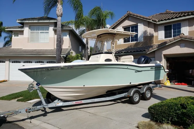 The Image of 2018 Grady-White Fisherman 216 boat on trailer in suburban driveway. - 0