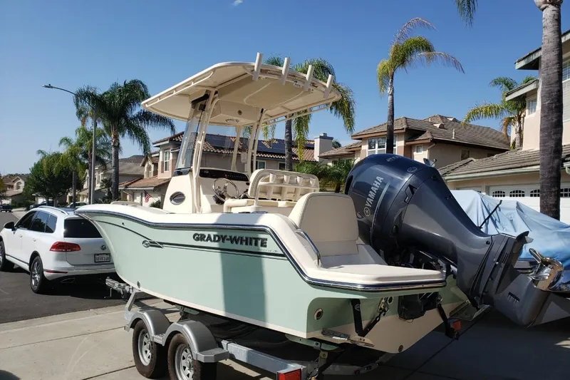 Slide: The Image of 2018 Grady-White Fisherman 216 boat on trailer in suburban driveway. - 2