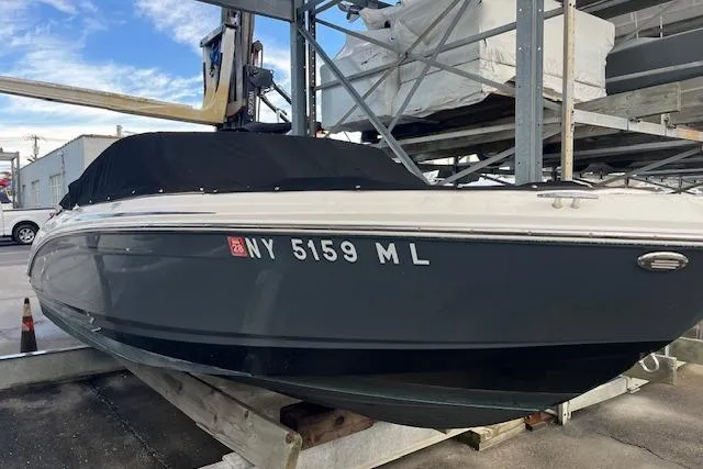 The Image of 2016 Chaparral 21 H2O Sport boat in storage, covered and docked. - 0