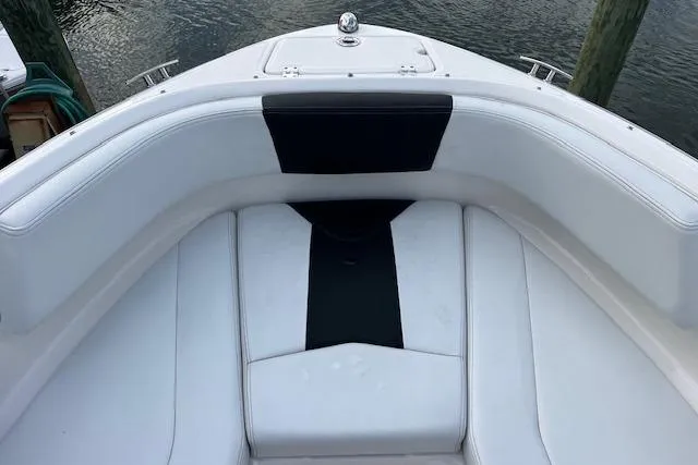 Slide: The Image of 2016 Chaparral 21 H2O Sport boat bow seating with white and black upholstery. - 10