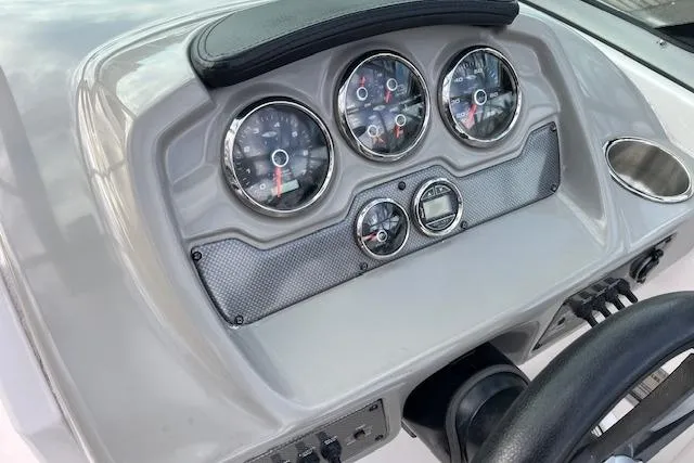 Slide: The Image of Dashboard of 2016 Chaparral 21 H2O Sport boat with gauges and steering wheel. - 15