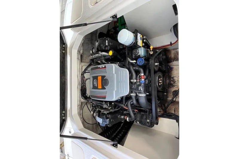 Slide: The Image of Engine compartment of a 2016 Chaparral 21 H2O Sport boat, showcasing detailed components. - 17