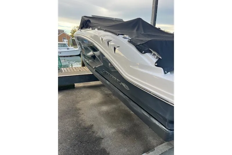 Slide: The Image of 2016 Chaparral 21 H2O Sport boat covered and docked at marina. - 3