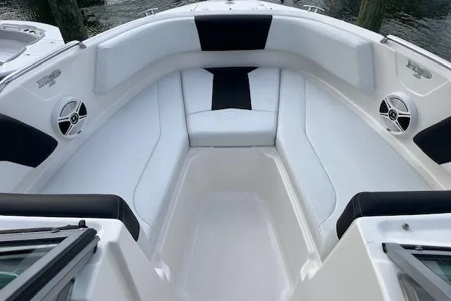 Slide: The Image of 2016 Chaparral 21 H2O Sport boat interior with white seating and speakers. - 9