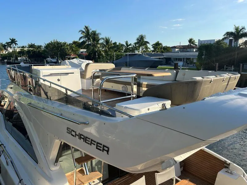 Slide: The Image of Luxury Schaefer 510 yacht docked, showcasing sleek design and spacious deck, 2019 model. - 21
