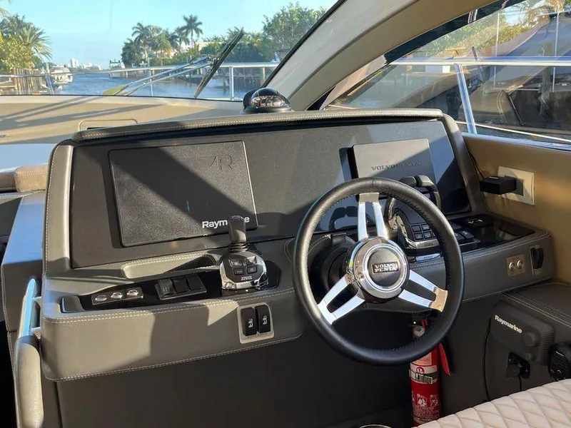 Slide: The Image of Interior of a 2019 Schaefer 510 yacht cockpit with steering wheel and navigation controls. - 26