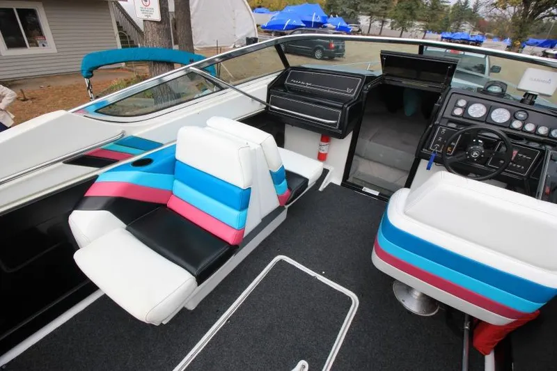 Slide: The Image of 1989 Formula 223 SS boat interior with colorful seating and dashboard controls. - 11