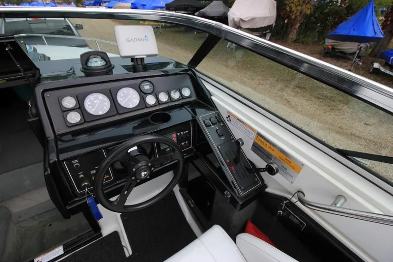 Slide: The Image of 1989 Formula 223 SS boat dashboard with Garmin navigation system and steering wheel. - 14
