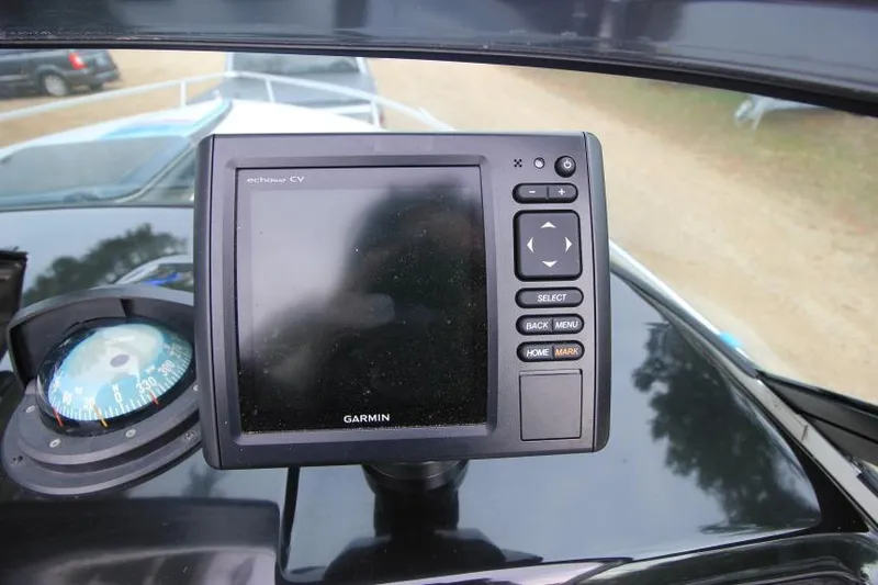 Slide: The Image of Garmin navigation system and compass on 1989 Formula 223 SS boat dashboard. - 17