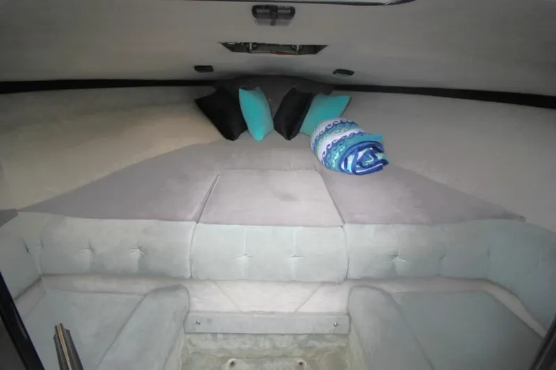 Slide: The Image of Interior cabin of a 1989 Formula 223 SS boat with cushions and pillows. - 18