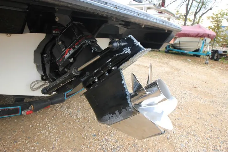 Slide: The Image of 1989 Formula 223 SS boat outdrive with stainless steel propeller on gravel surface. - 5