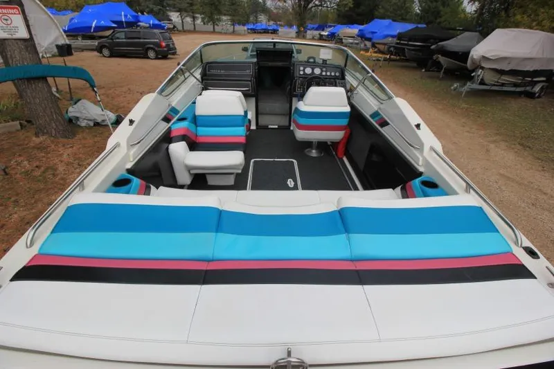 Slide: The Image of 1989 Formula 223 SS boat interior with colorful seating and dashboard view. - 9