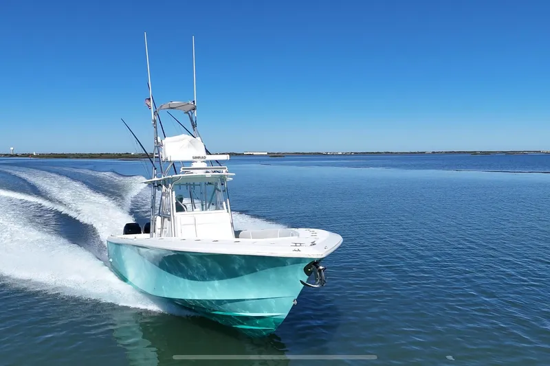 Slide: The Image of 2013 SeaVee 39B Center Console boat cruising on calm blue waters. - 1