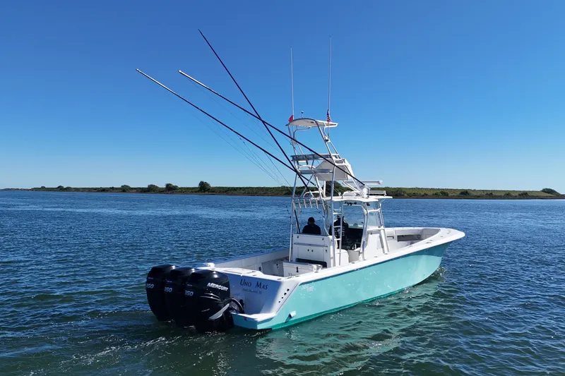 Slide: The Image of 2013 SeaVee 39B Center Console boat on calm water with clear blue sky. - 11