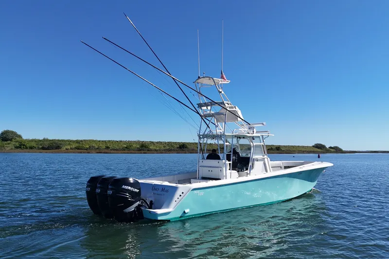 Slide: The Image of 2013 SeaVee 39B Center Console boat with triple Mercury engines on calm water. - 15