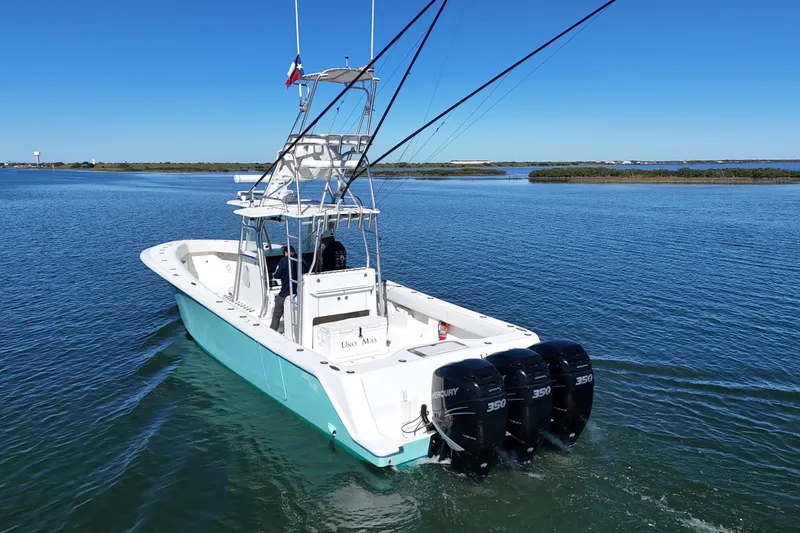 Slide: The Image of 2013 SeaVee 39B Center Console boat with triple Mercury 350 engines on open water. - 16