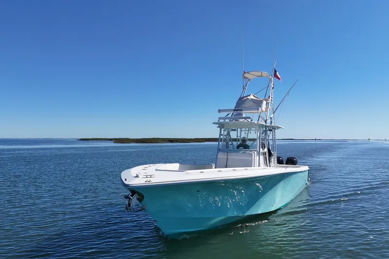 Slide: The Image of 2013 SeaVee 39B Center Console boat cruising on calm waters under clear blue skies. - 17