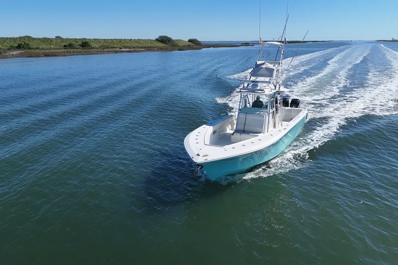 Slide: The Image of 2013 SeaVee 39B Center Console boat cruising on open water under clear blue sky. - 18