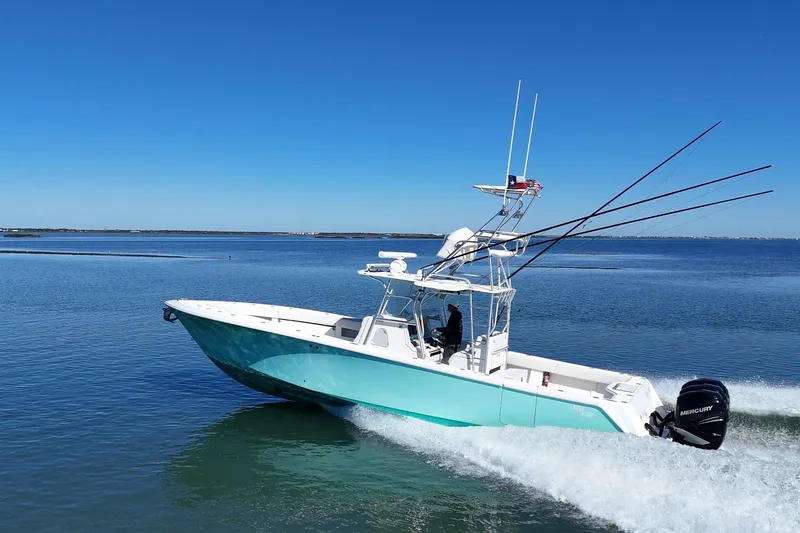 Slide: The Image of 2013 SeaVee 39B Center Console boat cruising on calm blue waters. - 2