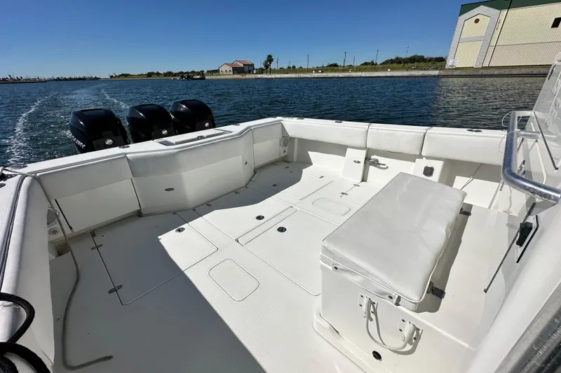 Slide: The Image of 2013 SeaVee 39B Center Console boat with spacious deck and triple outboard engines. - 23