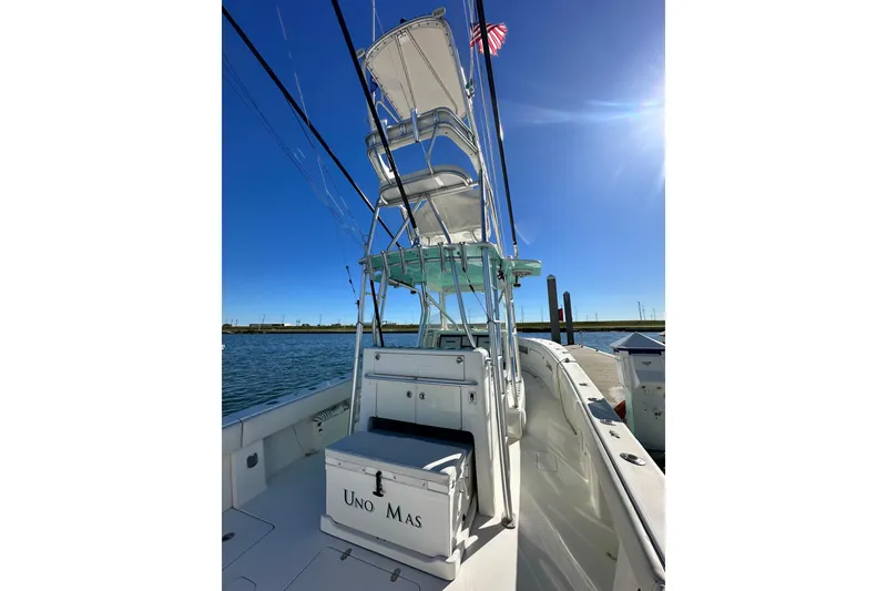Slide: The Image of 2013 SeaVee 39B Center Console boat with tower, docked under clear blue sky. - 25