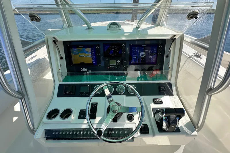 Slide: The Image of 2013 SeaVee 39B Center Console helm with advanced navigation displays and controls. - 29