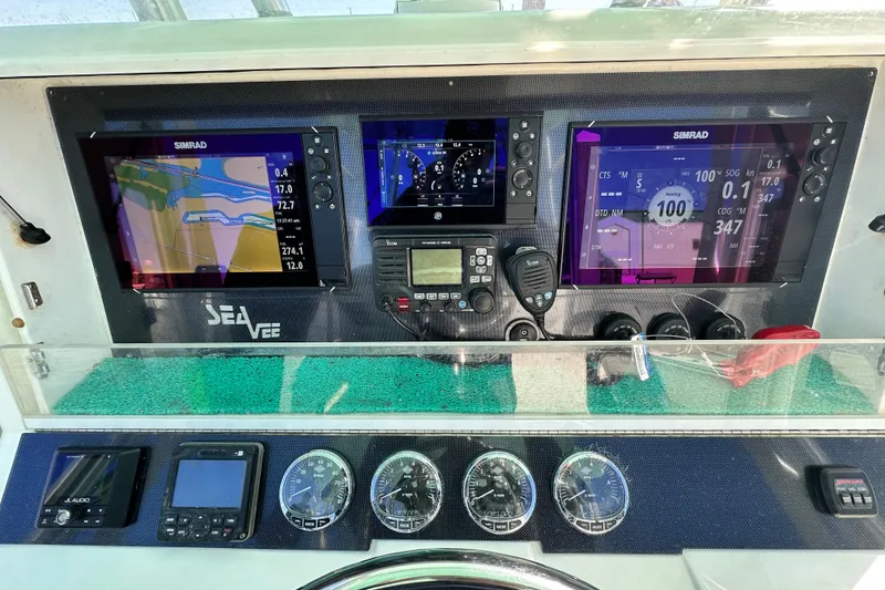 Slide: The Image of 2013 SeaVee 39B Center Console dashboard with Simrad navigation displays and controls. - 30